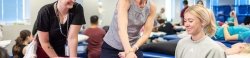 Faculty demonstrating to students in the physical therapy lab.