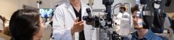 Optometry faculty demonstrates lab equipment to students.