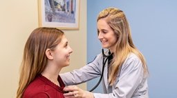 Doctor listening to patient's lungs