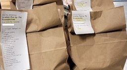 To-go orders in brown bags.