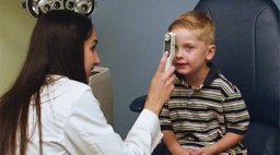 young child at being examined by eye doctor