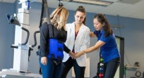 Physical therapist assisting patient