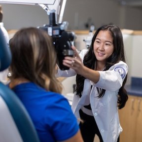 Optometry student checking a patient's eyes.