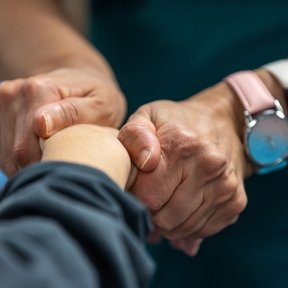 Patient getting their wrist checked by a professional 