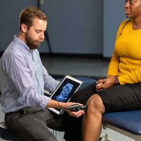 Healthcare professional checking a patients knees