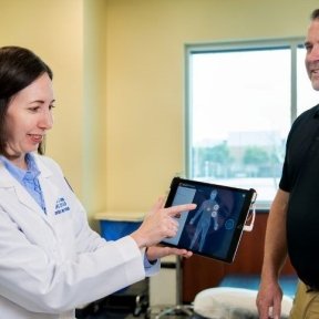 Orthotics & prosthetics patient with doctor, looking at xray