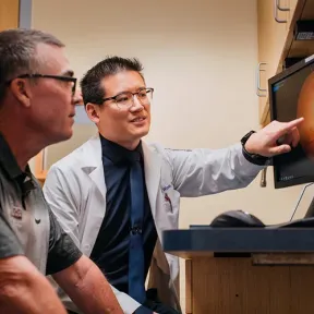 Man showing patient image of eye