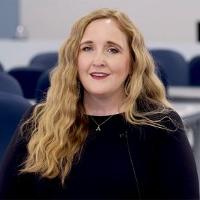 Katie Fluharty sits in a Speech-Language Pathology classroom.