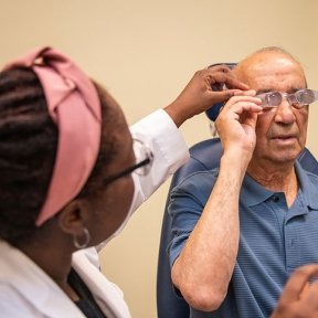 Man with doctor receivuing specialty vision services