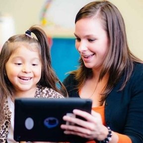 Speech-language pathologist works with young child.