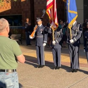 Military members hold flags.