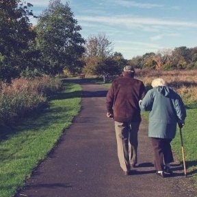 Senior couple walks a nature trail.