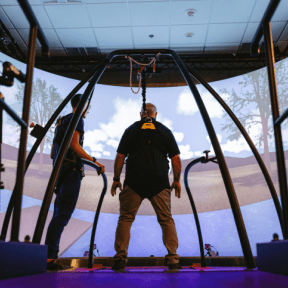 Patient using the CAREN system and being assisted by the physical therapist.