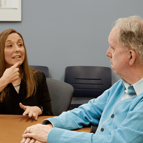 SLP demonstrates enunciation to a patient.