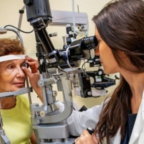 Optometrist performs eye woman at Midwestern University Eye Institute.
