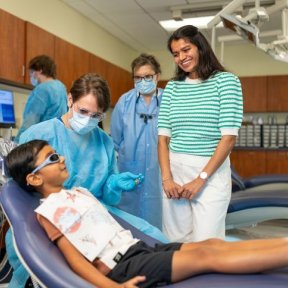 Young boy with his mother at dental exam.