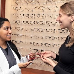 MWU optician shows frames to a customer.