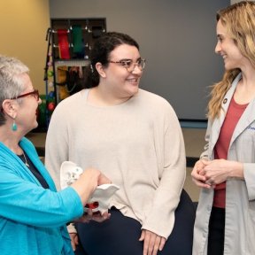 Clinicians meet with a patient.