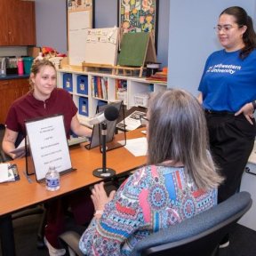 Speech language pathologist works with patient.