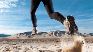 Woman running through a desert.