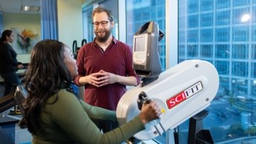 Physical therapist helping patient with mobility exercise.