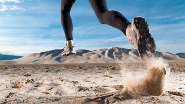 Woman running through a desert.