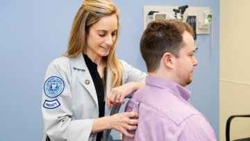 Dr. McKinnon performs an exam on a patient.