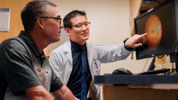 Optometrist showing patient something on the screen