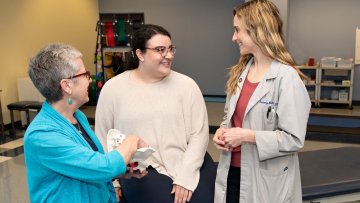 Clinicians meet with patient