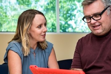 Therapists helps man communicate