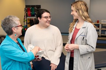 Clinicians meet with patient