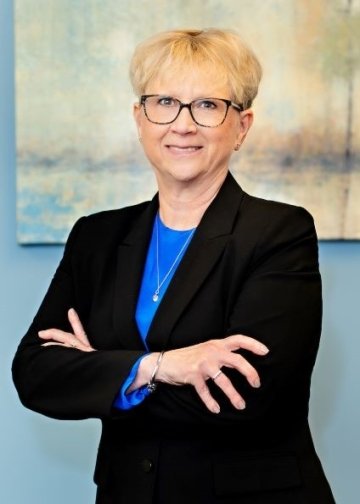 Woman poses with arms crossed