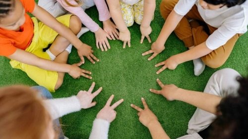 childrens fingers touching grass