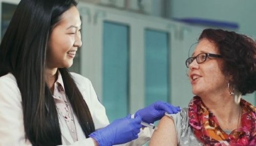 Woman receiving vaccination.