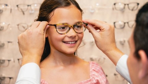 Young girl being fitted for glasses