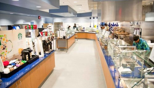 Cafeteria interior with cooks prepping lunch