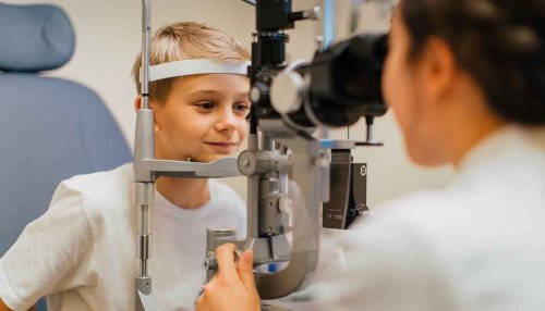 Child sitting in chair getting their eyes checked