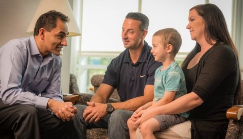 Child with his parents having a discussion with a clinical psychologist