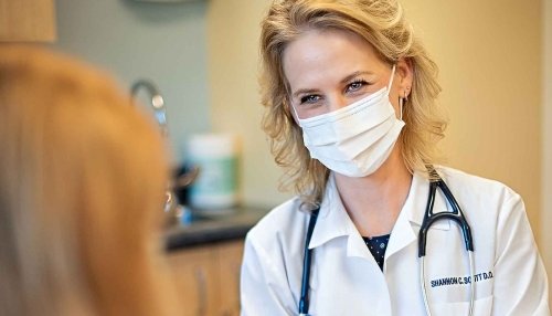 Dr. Shannon Scott in her white coat discussing health options with a patient