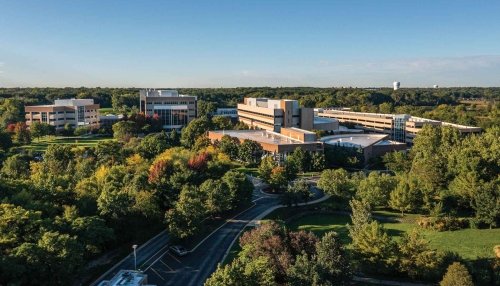 Aerial view of Downers Grove campus showing surrounding woods and water tower