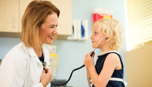 Dr. Shannon Scott letting a child patient use her stethoscope