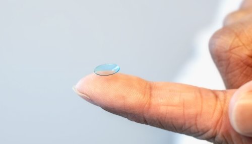 Contact lens laying on a woman's finger.