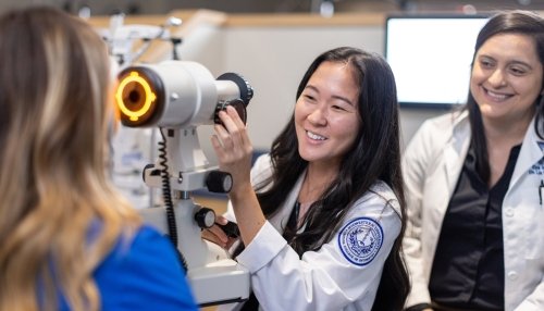 Faculty and students in optometry lab.