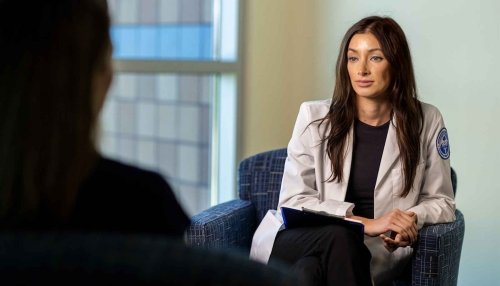 Psychologist sitting in an armchair and listening to a patient