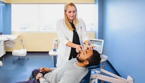 Optometrist examining patient's eye.