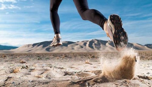 Woman running through a desert.