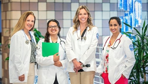 Group of four adult-gerontology nursing students and faculty.