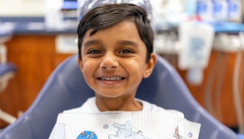 child smiling in dental exam chair