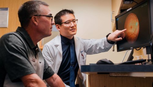 Optometrist showing patient something on the screen