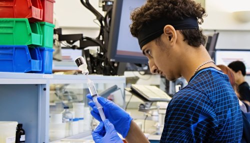 MWU PharmAcademy participant measures dosage in pharmacy lab.